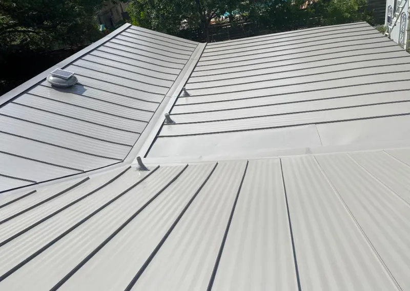 Solar attic fan installed on a metal roof for Roof Ventilation in Hartford